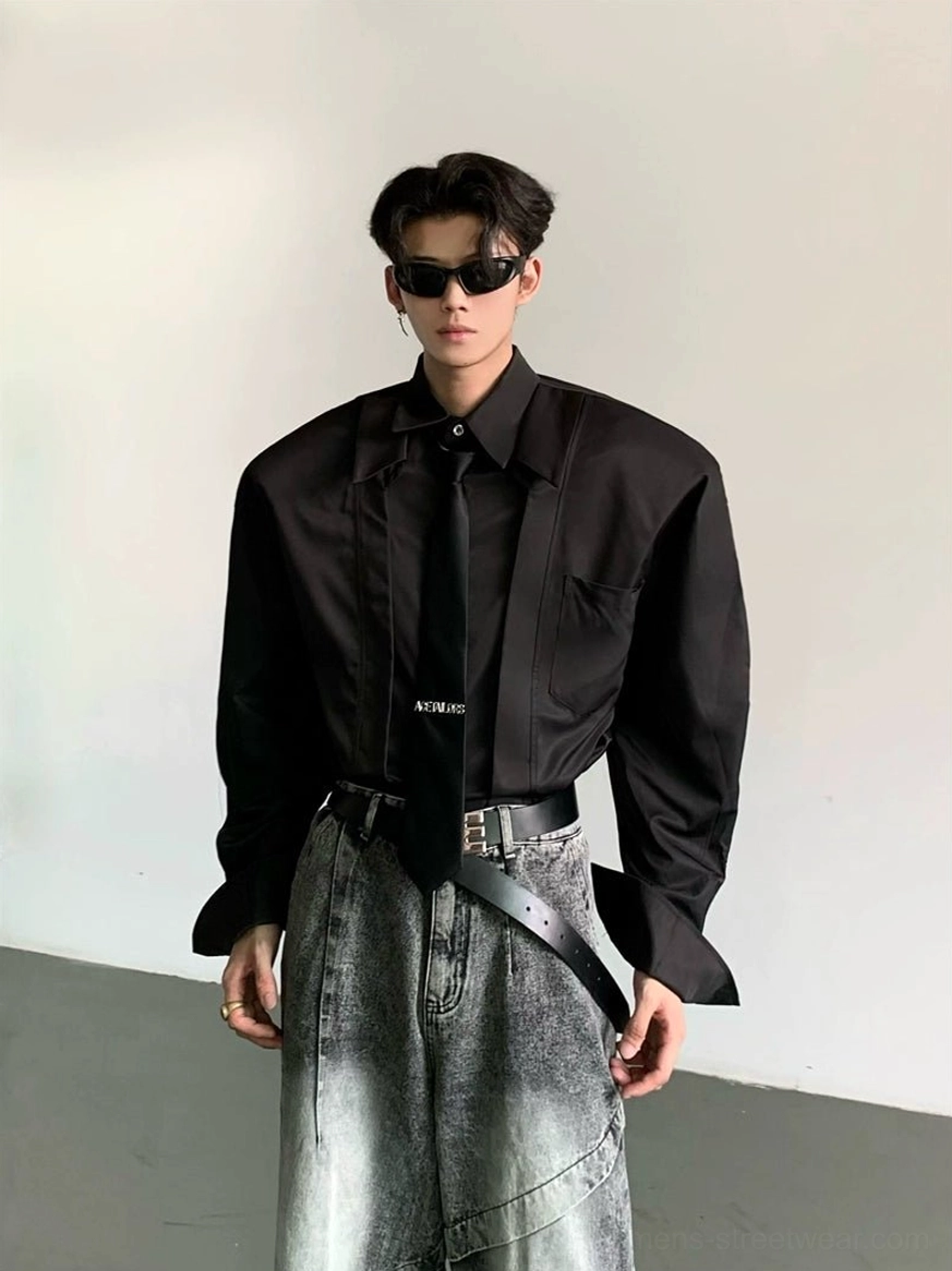 Black oversized wide-shoulder dress shirt showing chest pocket split cuffs broad collar and relaxed Korean streetwear fit