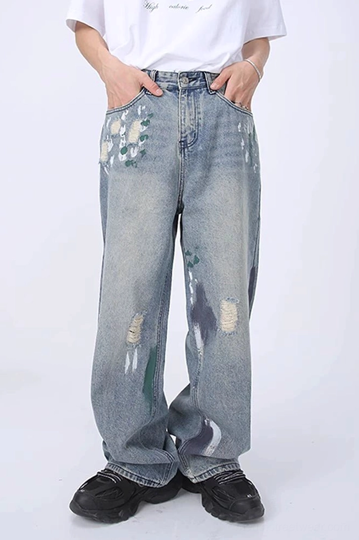 Full front view of light blue paint splatter distressed wide leg jeans with high waist, faded wash, frayed tears, and relaxed streetwear fit