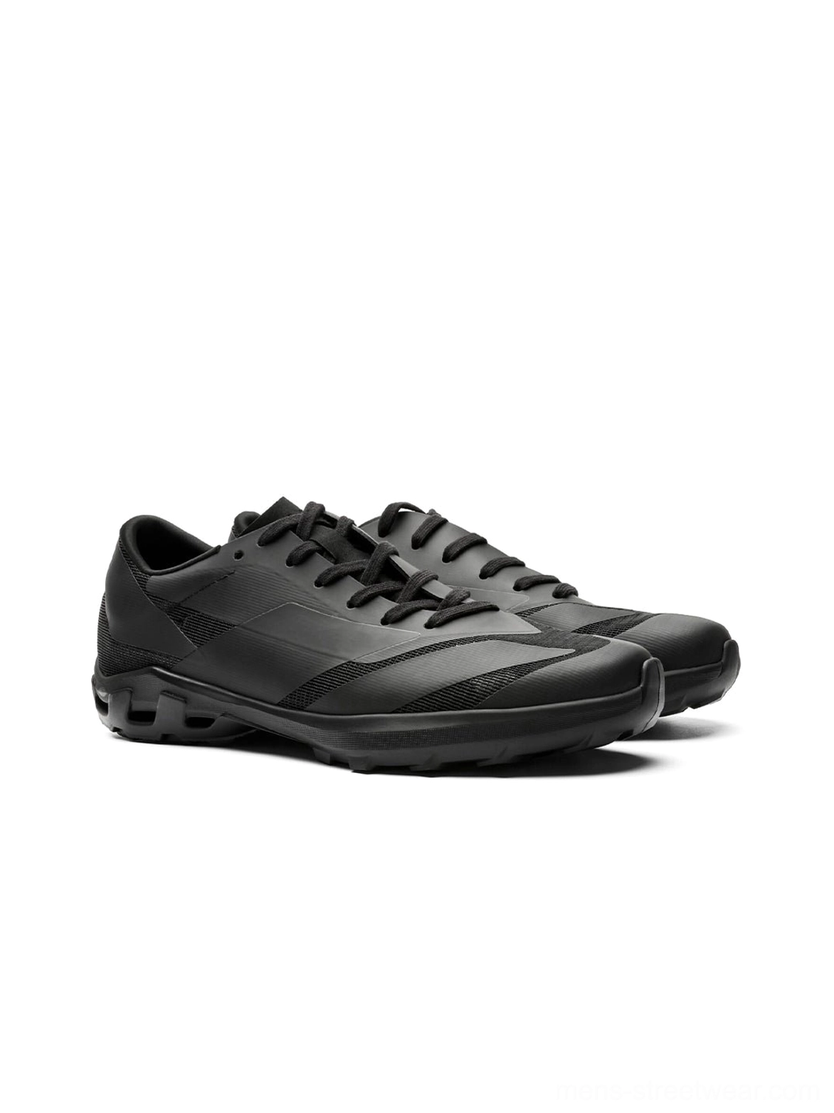 Pair of all-black low-profile arch-support sneakers displayed side by side, featuring matte uppers, geometric details, and lace-up construction