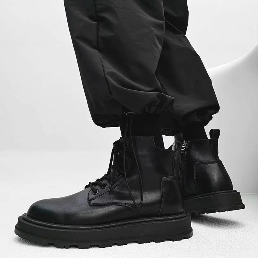 Pair of black platform combat boots viewed from the rear side showing structured heels, clean leather panels and thick rubber soles