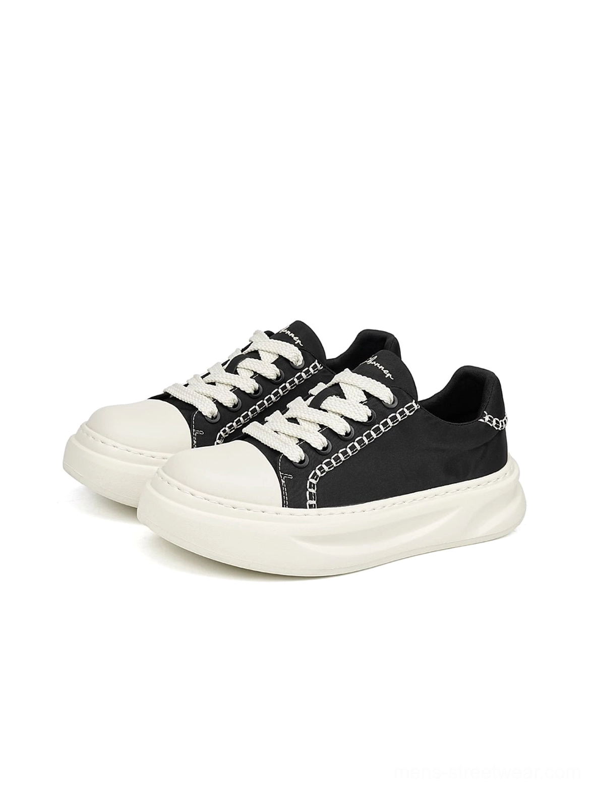 Pair of black platform sneakers with polished chain trim, white contrast stitching, white toe caps, and thick rounded soles