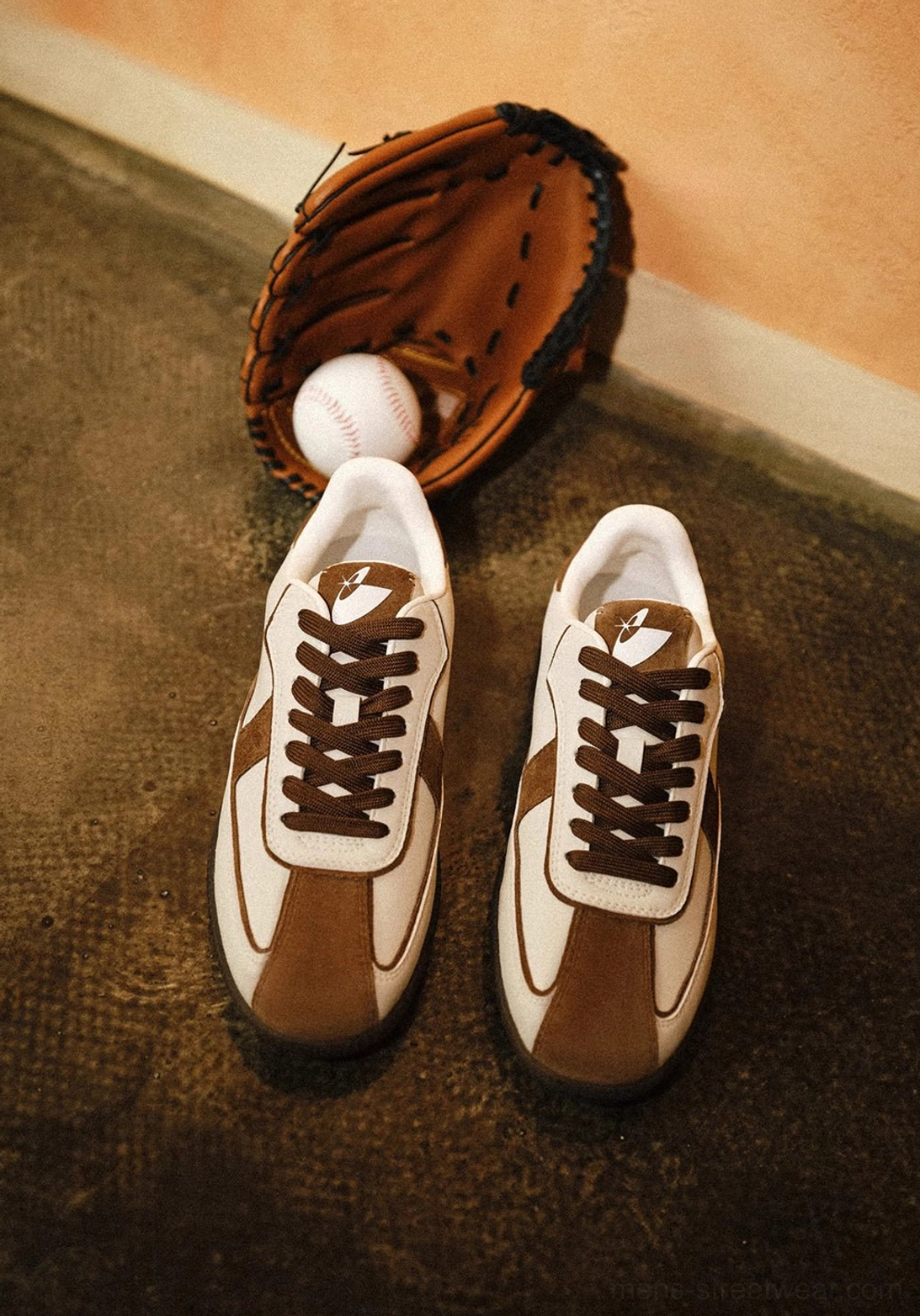 Pair of brown and white retro gum sole sneakers arranged with a baseball glove and ball for vintage sportswear styling