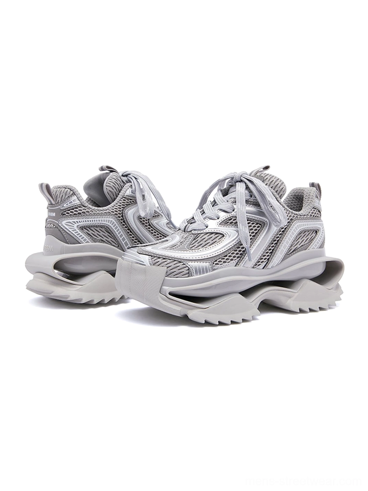 Pair of silver sculpted sole sneakers with layered wavy upper details and rugged traction outsole shown from a left three-quarter angle