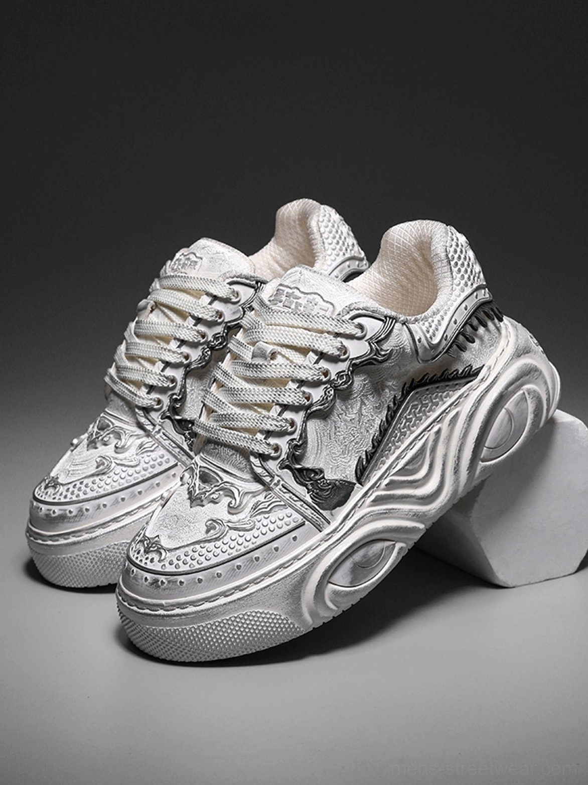 Pair of matching white Wukong-inspired sculpted platform sneakers with distressed tonal finish and chunky streetwear soles