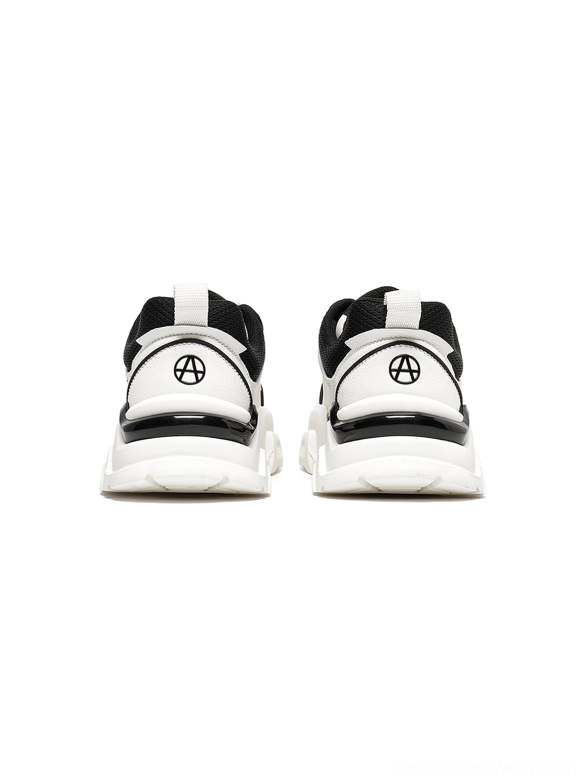 Paired platform sneakers frontal view showing symmetric geometric design balanced cutout elements and lace-up closure system