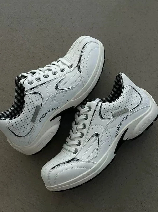 Paired white retro runner sneakers viewed from above with laces, breathable perforated panels, and visible checkered collar lining
