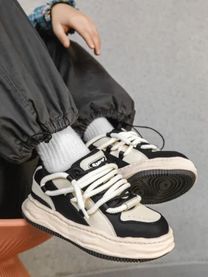 Paneled wavy platform sneakers worn with cropped dark cargo pants and white crew socks in a Korean streetwear outfit