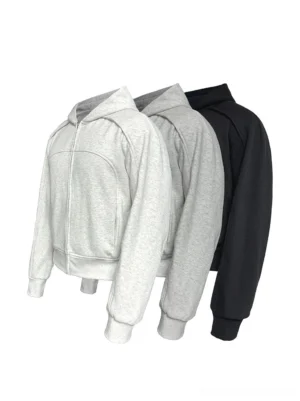 Panelled cropped zip-up hoodie in black and heather gray color options shown in front flat lay view