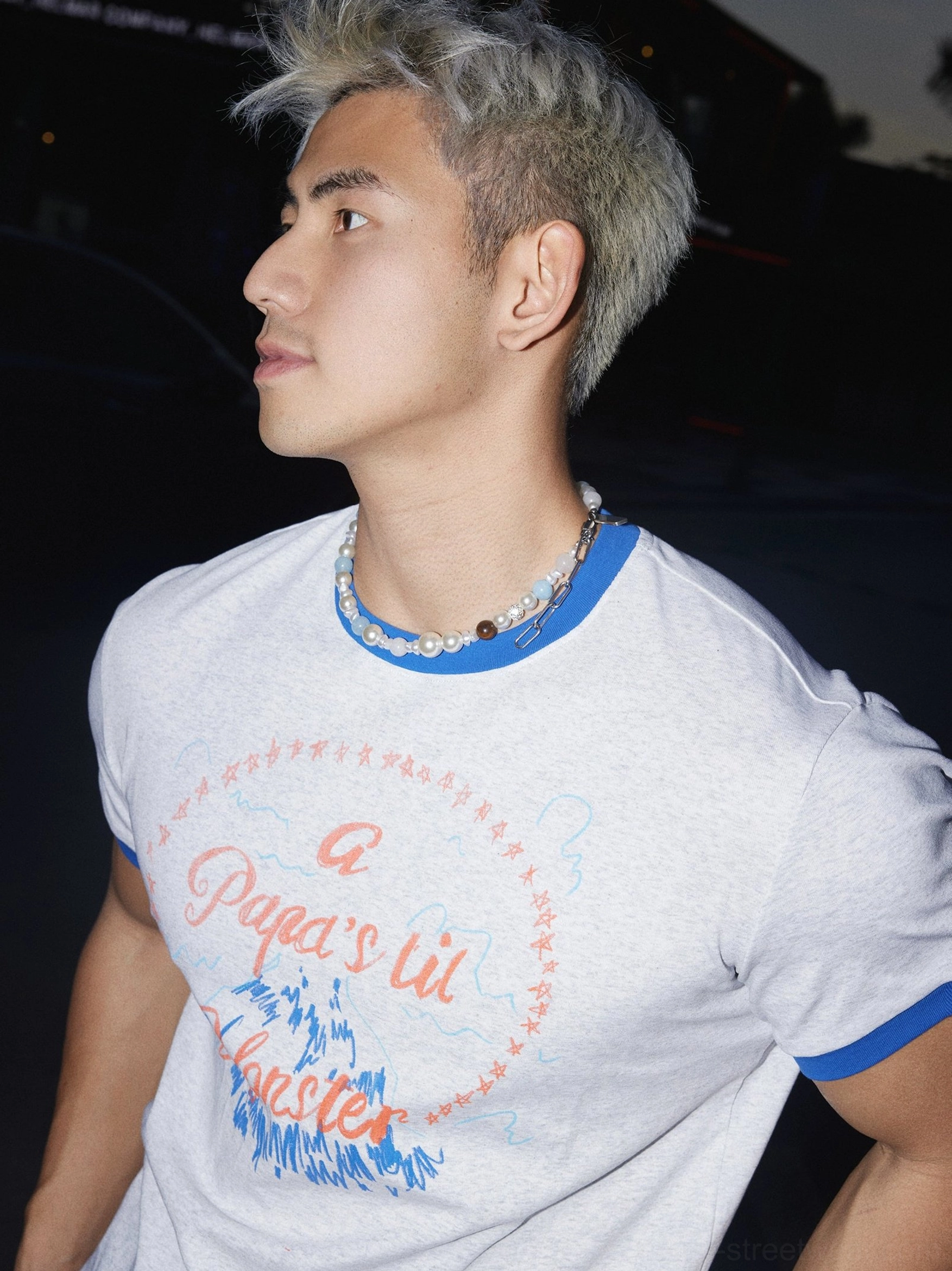 Profile close-up showing the blue crew neck trim and fitted heather grey fabric of the Papa's Lil Monster graphic streetwear T-shirt