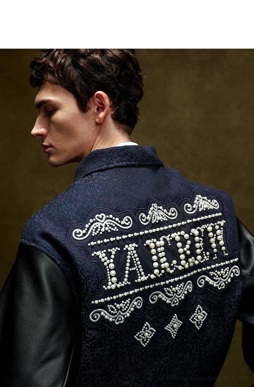 Pearl embellished contrast sleeve varsity jacket featuring a textured navy body, decorative pearl detailing, snap front, and ribbed trims