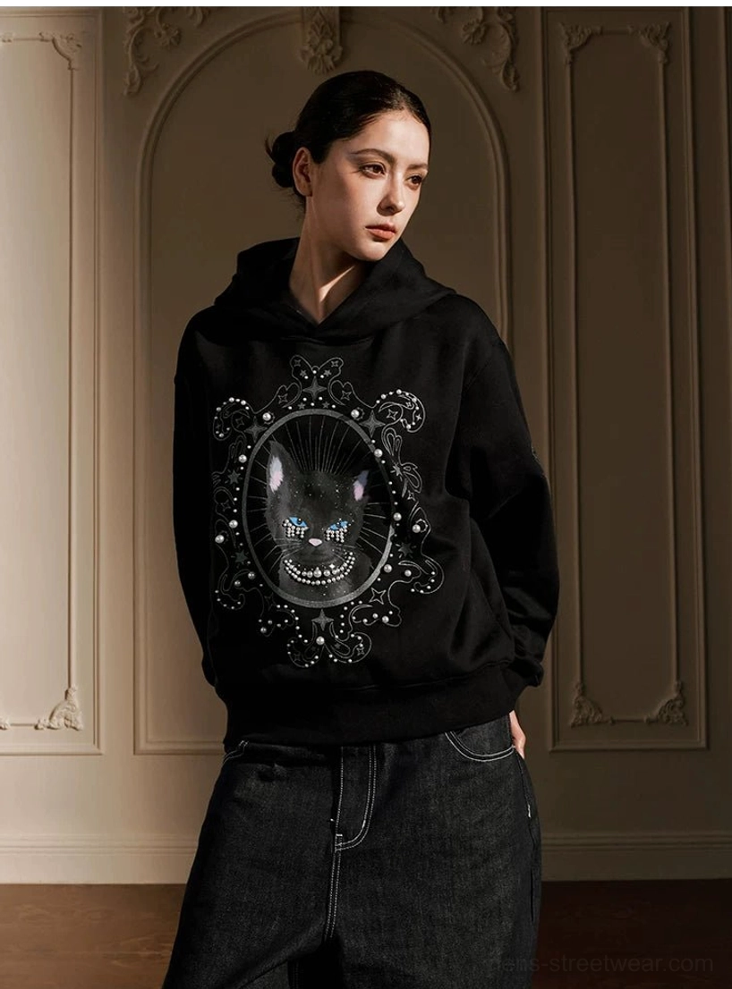 Pearl embellished mystic cat graphic hoodie styled with dark denim in gothic Korean streetwear look