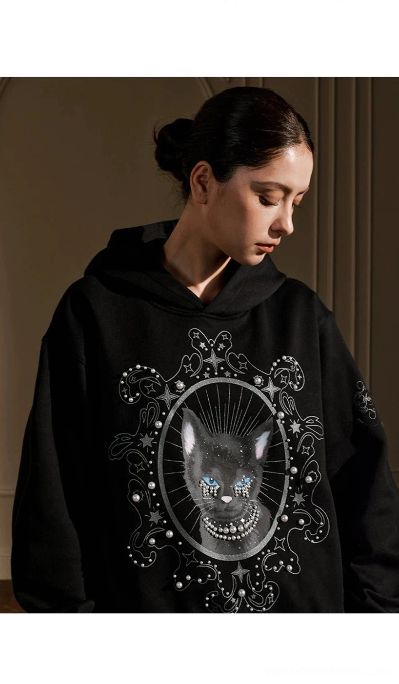 Side view of black pearl embellished mystic cat oversized gothic hoodie with ornate chest graphic