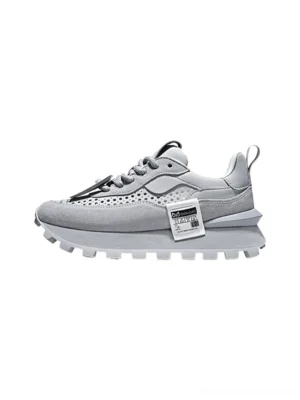 Gray perforated leather platform sneakers with rounded toe, lace-up front, layered outsole, and serrated rubber tread on white background