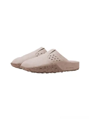 Perforated wide-fit suede men's mules in light beige with laser-cut airflow holes and rugged textured rubber outsole shown from a top-down view