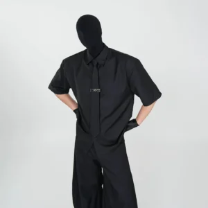 Black Phantom Noir short sleeve button up streetwear shirt with matching necktie and metallic tie bar styled with black wide leg trousers