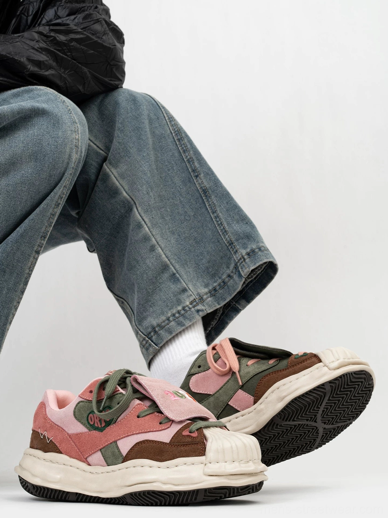 Pair of pink brown and olive green Acubi streetwear sneakers with decorative embroidered patches and thick off-white rubber outsole