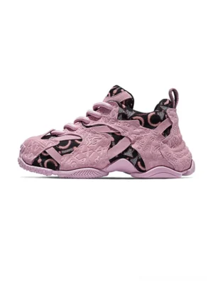 Pink embroidered chunky dad sneakers shown in a side front product view with dusty pink suede overlays, monogram-style jacquard panels, lace-up closure, and layered rubber outsole