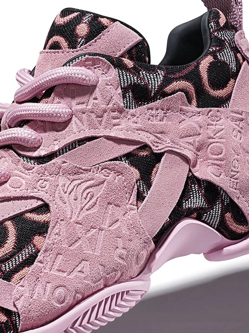 Close-up of pink embroidered chunky sneakers highlighting embossed suede overlay details, round pink laces, jacquard side panels, and rubber sole edge