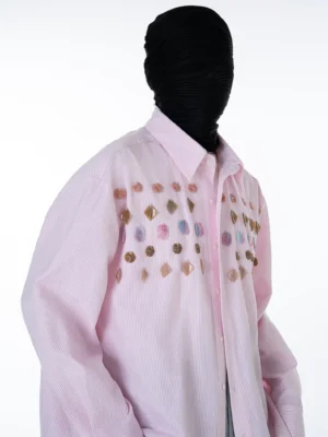 Side close-up of pink pinstripe button-up shirt with reflective gem embellishments across the chest and classic pointed collar