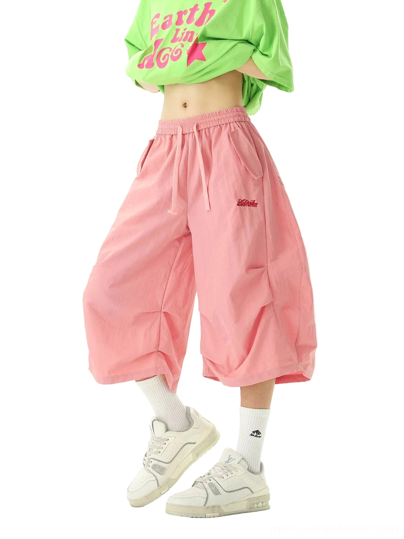 Front three-quarter view of pink oversized balloon jogger shorts with wide cropped legs elastic waist and embroidered waistband detail