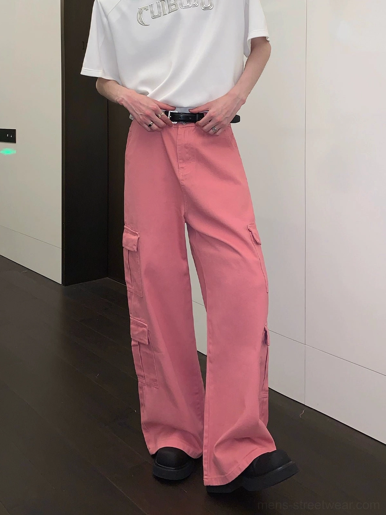 Front three-quarter view of dusty pink wide-leg cargo pants with symmetrical cargo pockets and classic belt loops