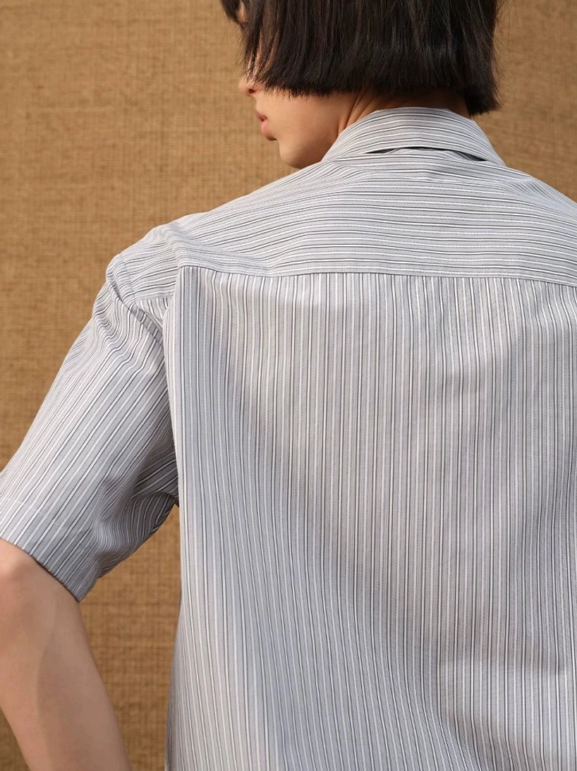 Rear close-up view showing the vertical stripes, back yoke seam, and short sleeves of a Korean streetwear shirt