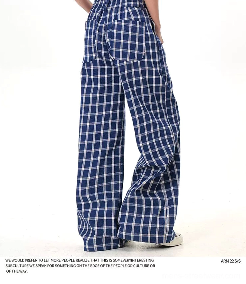 Plaid button-front wide-leg pants product detail showcasing the oversized check pattern, tailored waistband, and modern streetwear fit