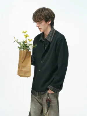 Black plaid collar layered knit shirt jacket shown from a left three-quarter angle on a male model in Korean streetwear styling