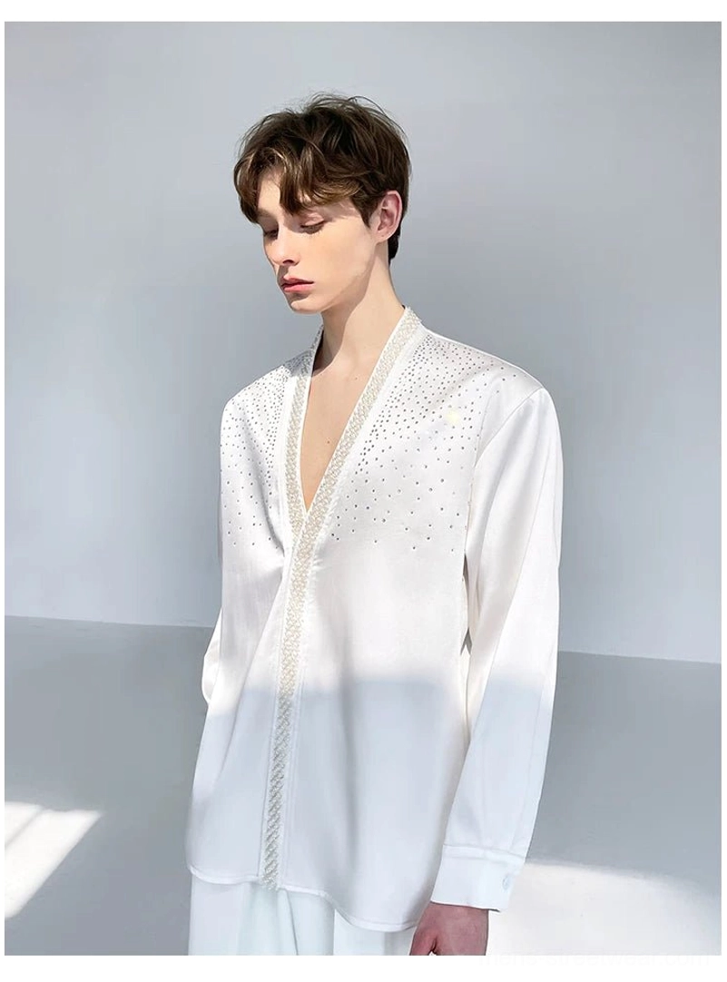 Side three-quarter view of a plain ivory satin men's shirt with long loose sleeves, open front, and relaxed Korean streetwear silhouette