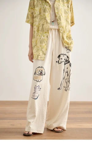 Ivory playful pup doodle print relaxed wide-leg lounge pants shown in a full front outfit look