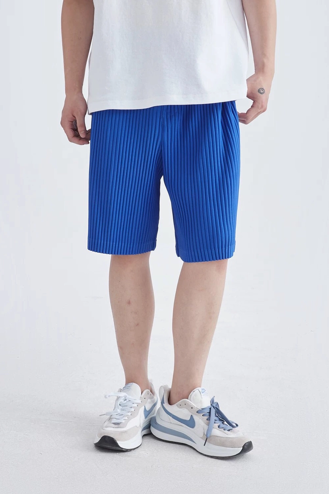 Pleated streetwear shorts with lightweight drapey fabric for summer layering and casual outfits
