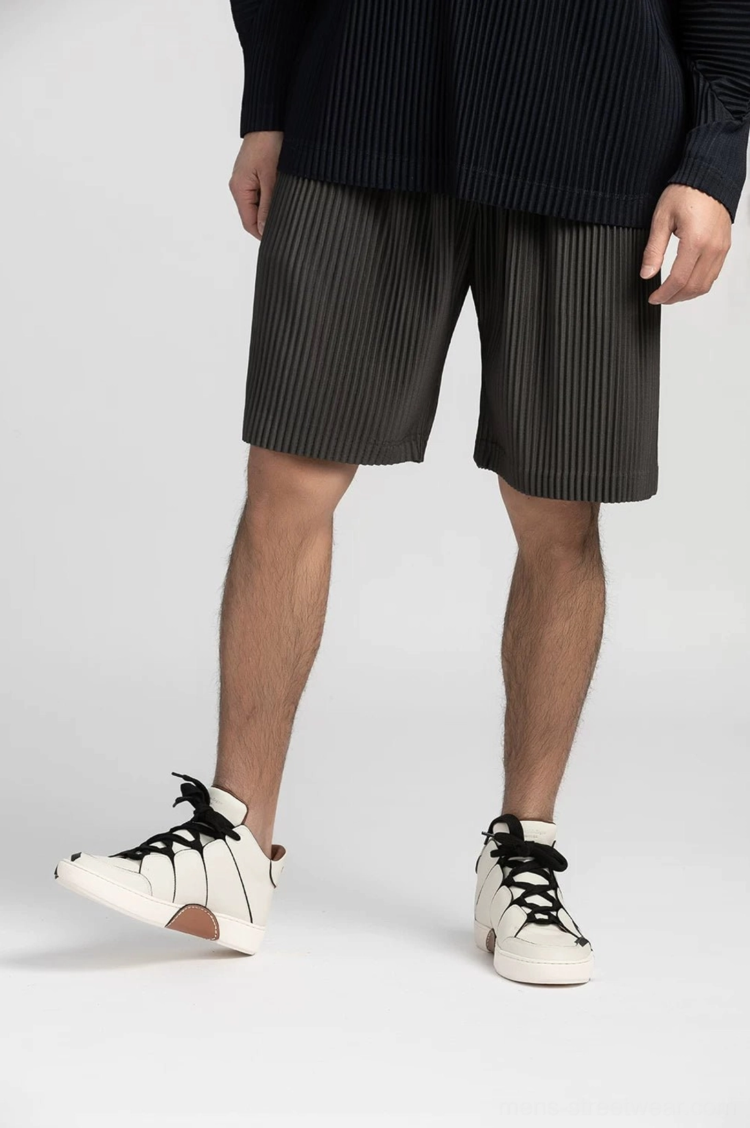 Pleated tech shorts in modern Korean streetwear style with relaxed straight-leg silhouette