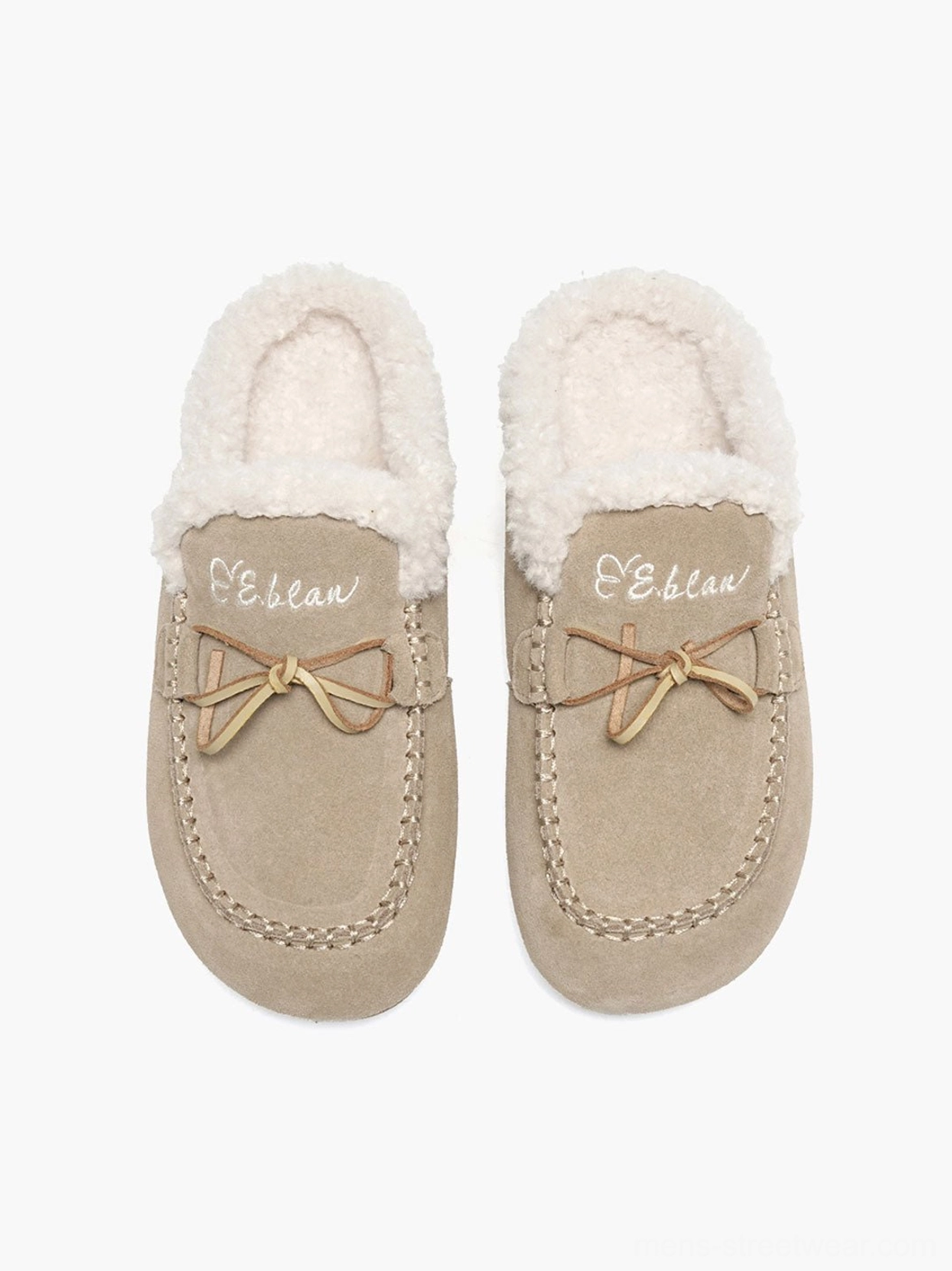 Front view of sand color plush-lined suede-look moccasin slippers with visible toe stitching and fleece trim