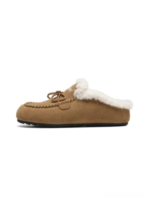 Tan plush-lined suede-look moccasin slippers in left side profile with fuzzy fleece collar and decorative lace bow