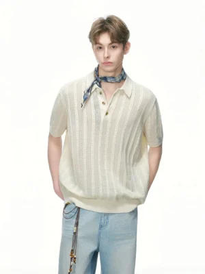 Cream white pointelle knit polo shirt with vertical openwork texture styled with light blue jeans and a plaid neck scarf