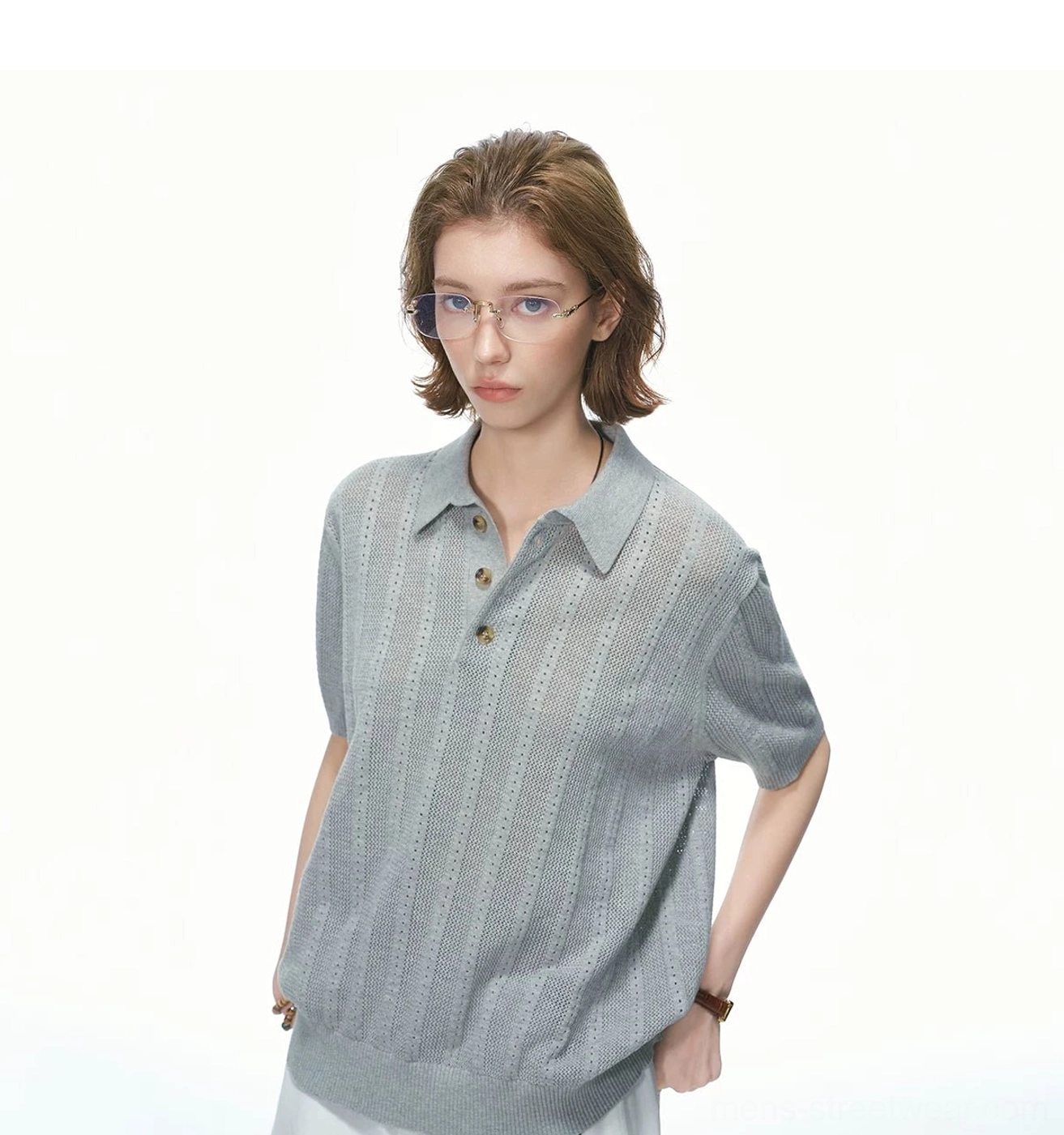 Close-up view of heather grey pointelle knit polo shirt showing vertical openwork knit stripes, ribbed cuffs, and hem