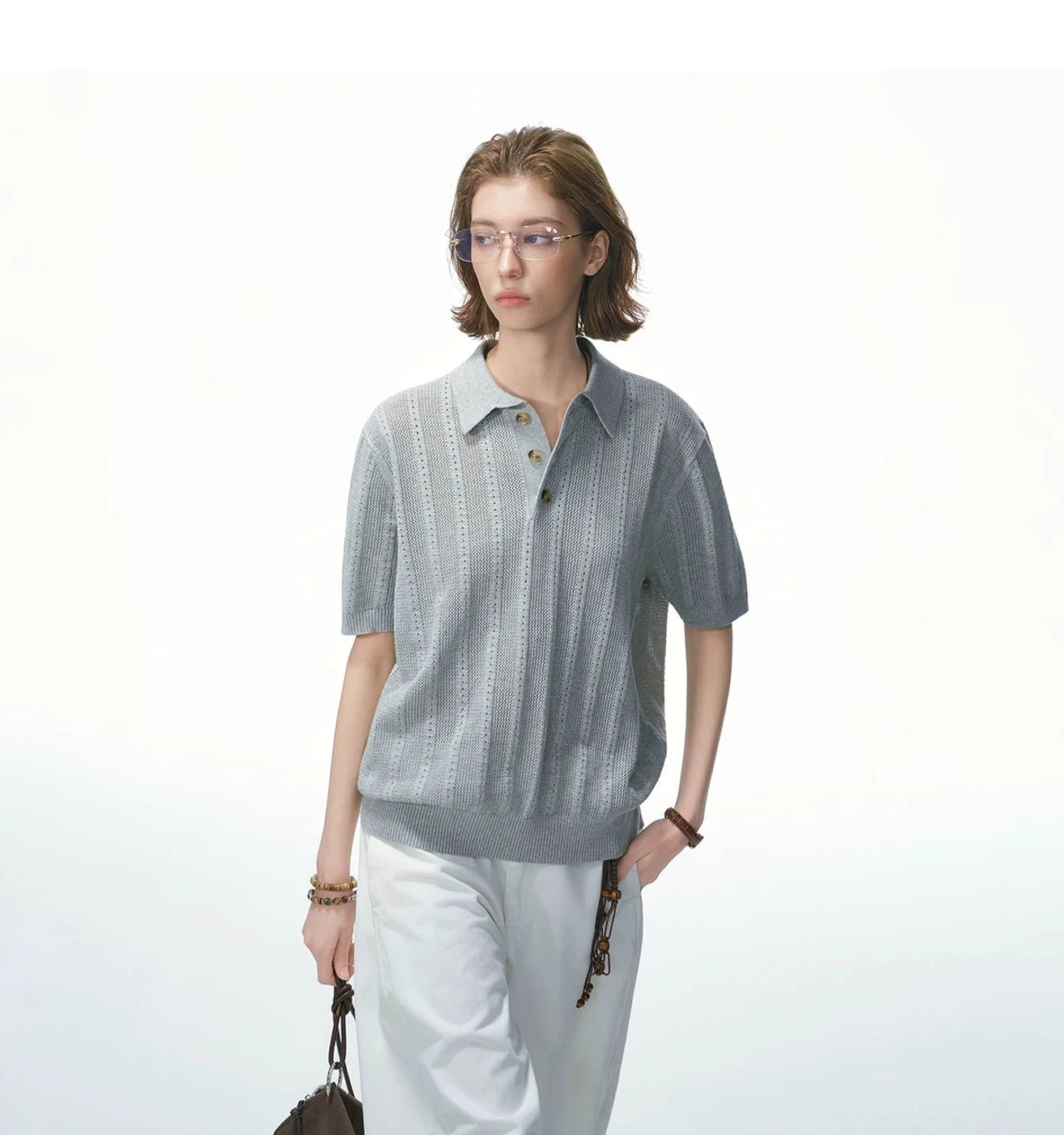Full-body heather grey pointelle knit polo shirt with vertical openwork texture styled with white wide-leg pants