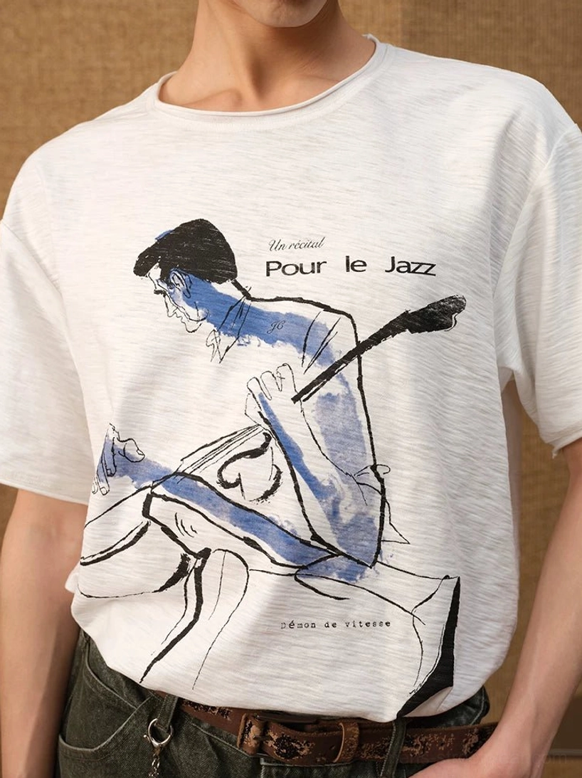 Close-up of Pour Le Jazz graphic T-shirt front showing hand-drawn upright bass player artwork and blue watercolor print