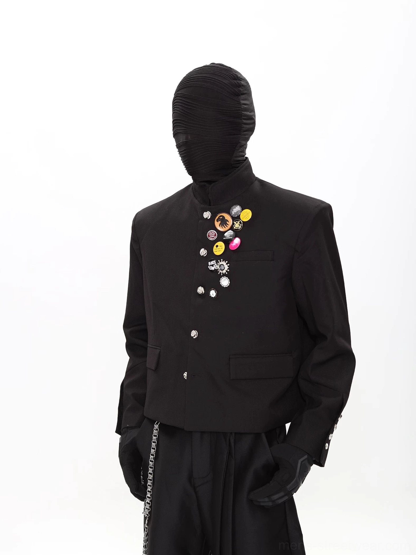 Front view of black punk scholar cropped stand-collar blazer and wide-leg pants suit with colorful chest badges