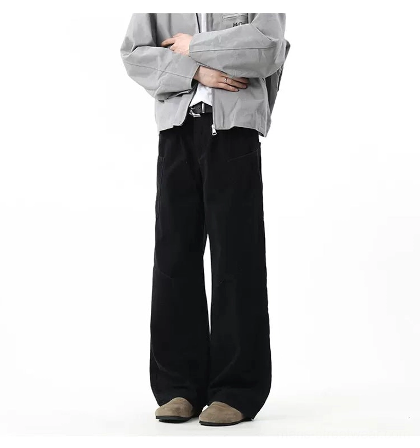Pure black wide-leg utility trousers with side cargo pockets and neat stitching styled with a cropped jacket and suede loafers