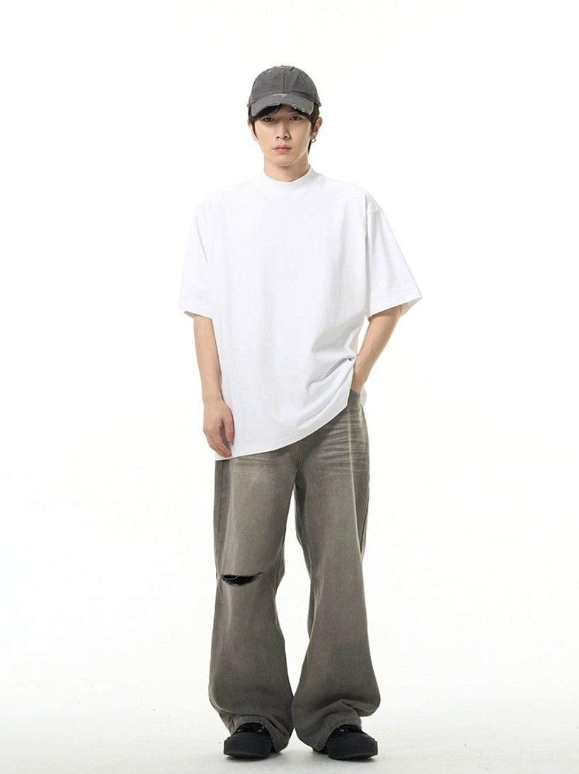 Pure white oversized crew neck short sleeve streetwear T-shirt styled with wide leg gray trousers
