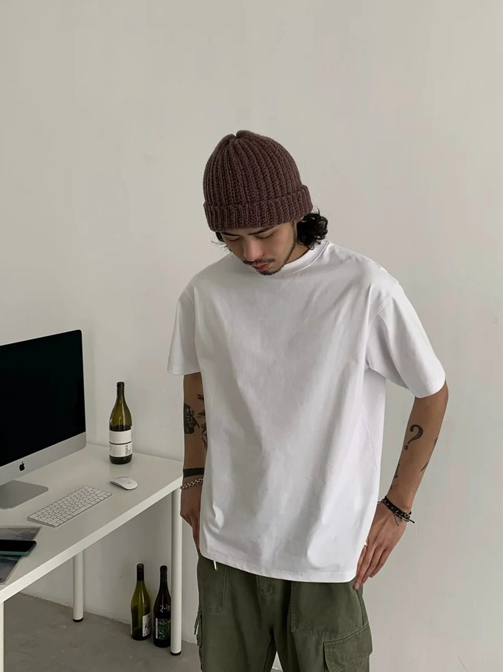 Pure white relaxed short sleeve crew neck t-shirt styled with green cargo pants and knit beanie