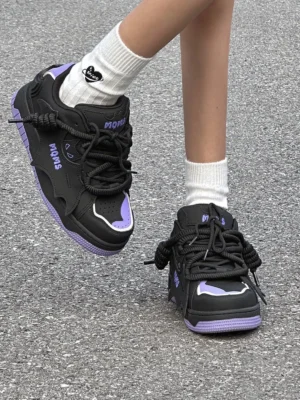 Purple bat graphic platform sneakers worn on street with white heart print crew socks showing chunky laces and skate-inspired silhouette