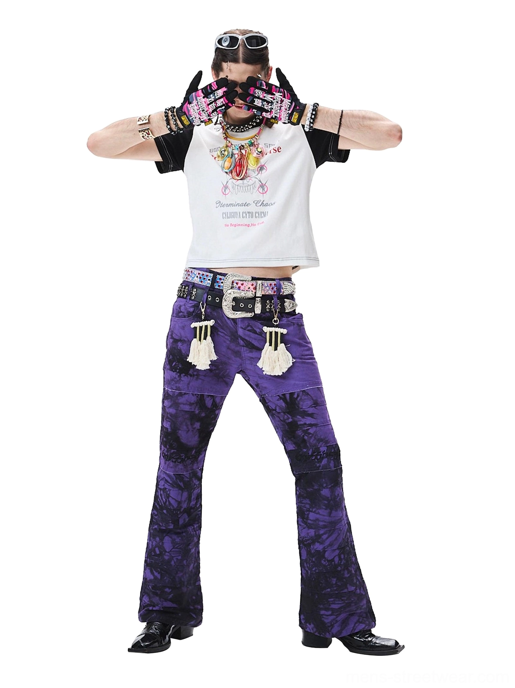 Full front view showing the relaxed fit and dramatic silhouette of purple-black tie-dye wide-leg trousers