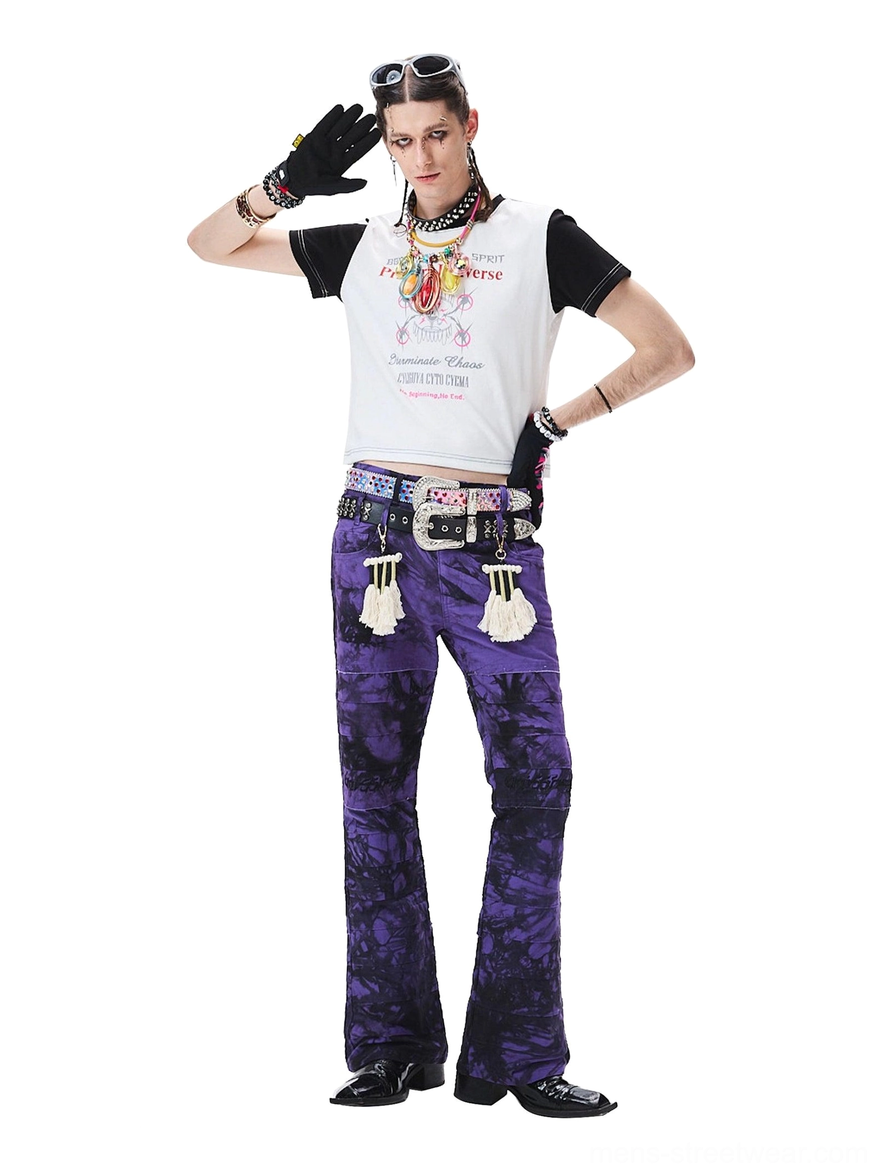 Side view of purple tie-dye flared streetwear trousers paired with a coordinated outfit and patterned gloves