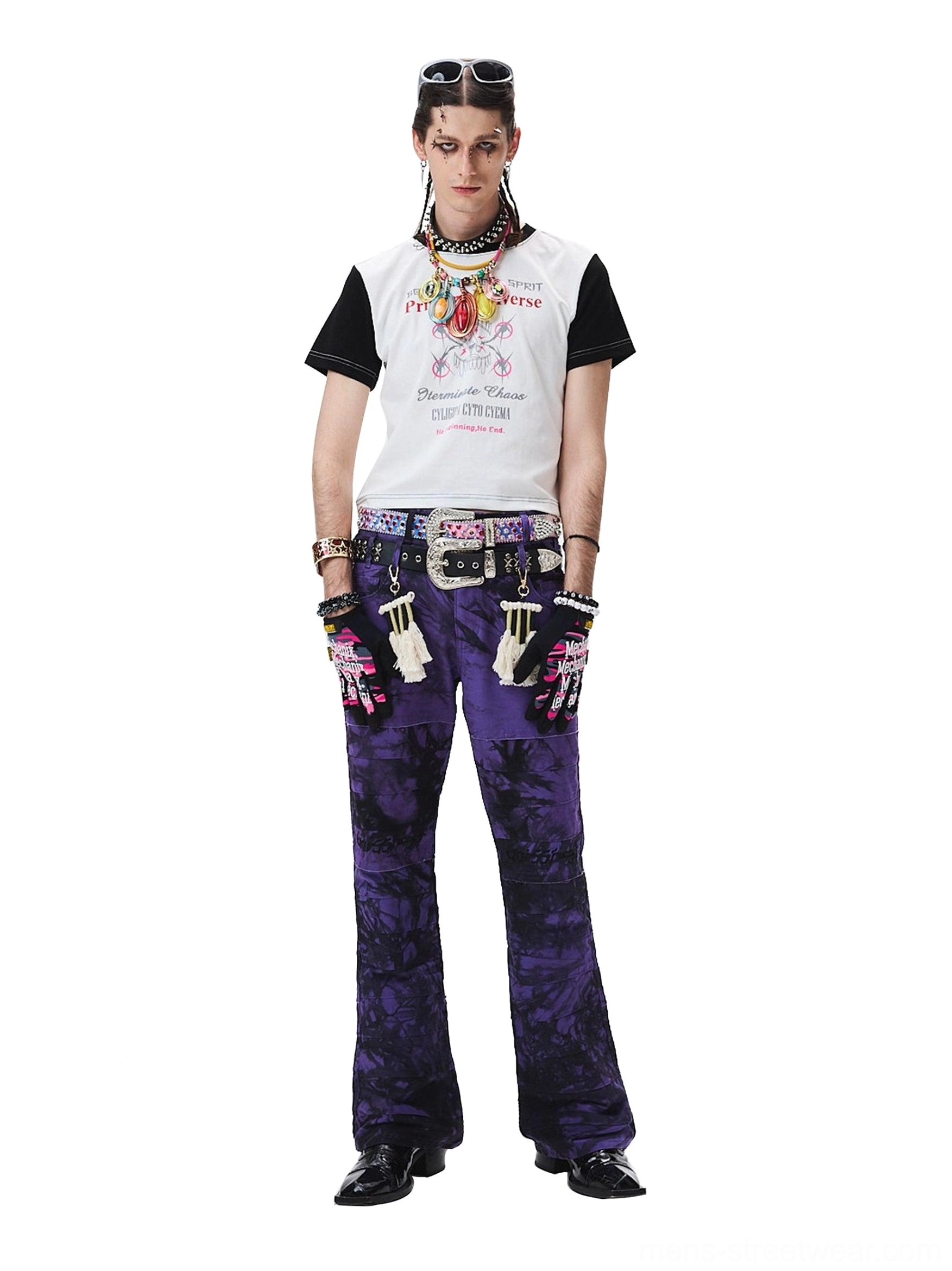 Three-quarter front view of purple tie-dye streetwear trousers showing the wide-leg drape and pocket styling