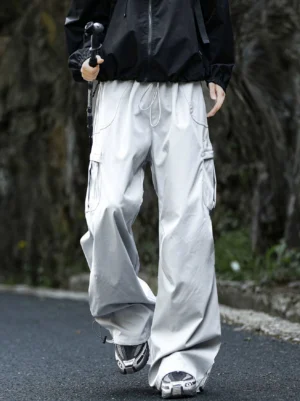 Light gray quick-dry wide-leg cargo pants shown in a front three-quarter walking view with functional cargo pockets