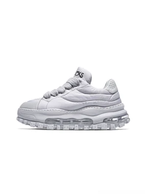 White padded quilted leather trail runner sneaker with chunky ripple sole and transparent air cushion midsole