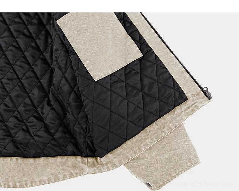 Quilted inner view of beige cotton work jacket with diamond stitched black lining and internal patch pocket