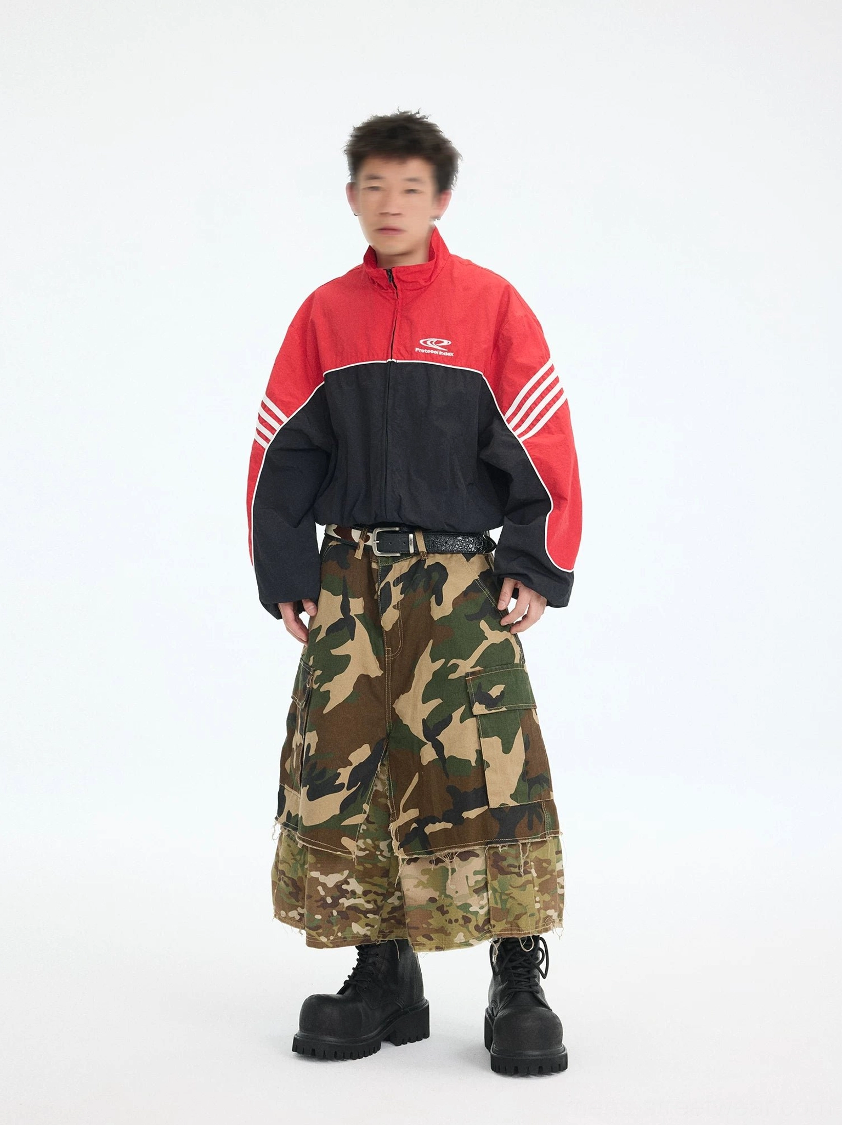 Men's cropped red black track jacket styled with camo cargo pants and chunky boots in a streetwear look